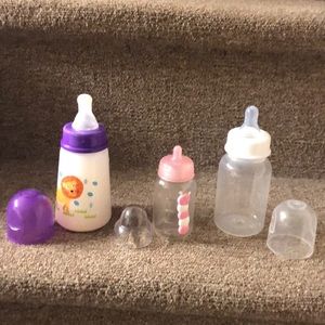 3 assorted baby bottles for play